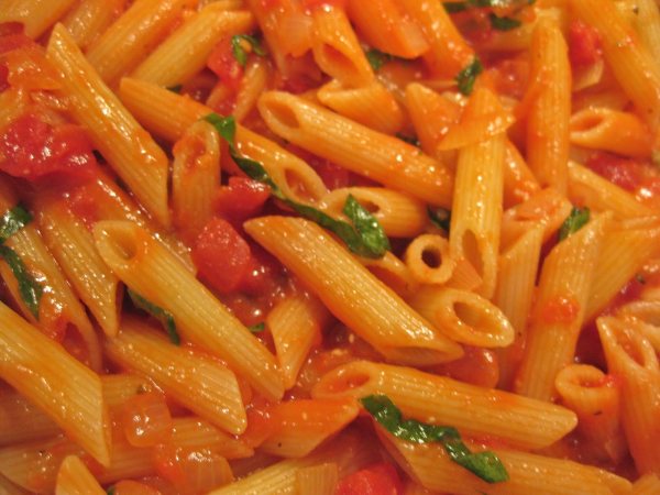 Served with sautéed bell peppers in our vodka cream sauce and topped with basil.