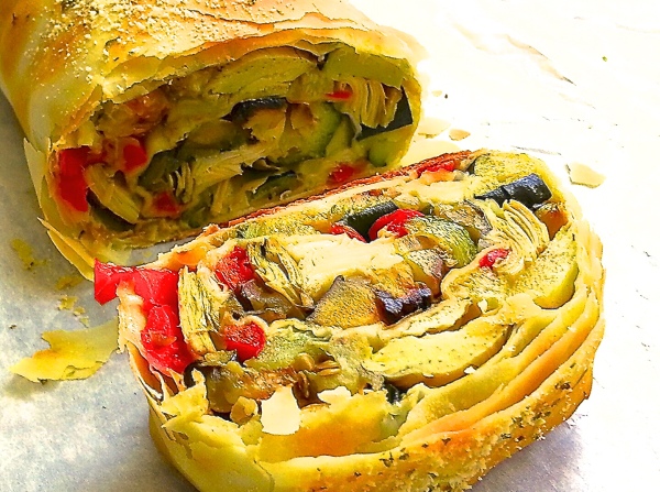 A mixture of roasted zucchini, squash, bell peppers, carrots & onions, wrapped in phyllo dough and baked until golden brown.
