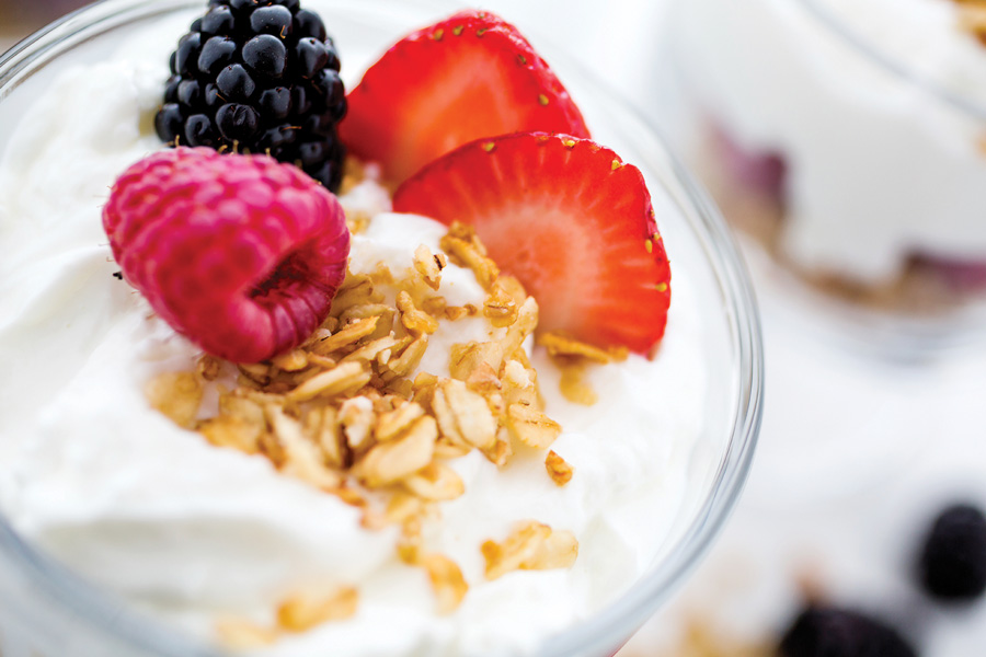 Individual yogurts & granola bars, whole fruit and a fresh fruit tray.